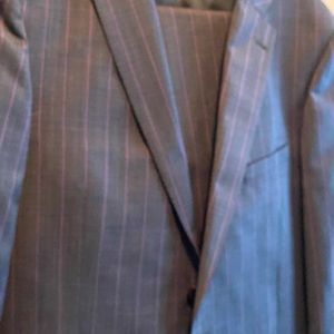 Purple striped grey suit. Only worn a couple times. Size 44r and 38r pants.